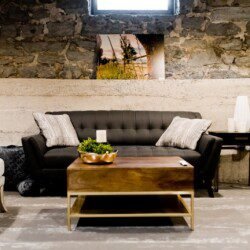 black flat screen tv turned on near gray sofa